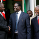 Kenyan President Mwai Kibaki (L) shakes hands with opposition leader Raila Odinga (C) while former UN Secretary General Kofi Annan (R looks on shortly after signing a contentious power sharing deal on 28 February 2008. Kenya's rival leaders signed a power-sharing deal mediated by Kofi Annan to end the country's post-election crisis which killed over 1500 people and left 600,000 displaced.